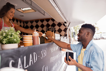 Image showing african american man buying wok at food truck