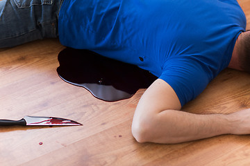 Image showing dead man body lying on floor at crime scene