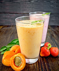 Image showing Milkshake apricot and strawberry in glassfulls on board