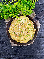 Image showing Meat stewed with cream in pan on black board top