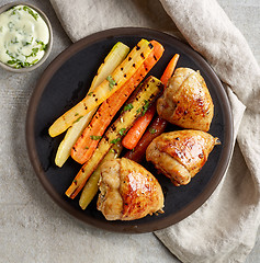 Image showing plate of grilled chicken legs and carrots