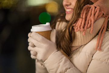 Image showing happy woman with coffee over christmas lights