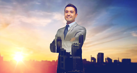 Image showing happy smiling businessman over city background