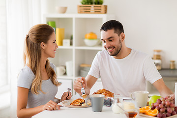 Image showing happy couple having breakfast at home