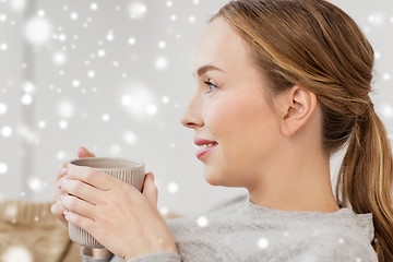 Image showing happy woman with cup or mug drinking at home