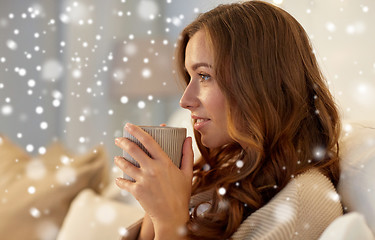 Image showing happy woman with cup of coffee in bed at home