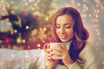 Image showing happy woman with cup of tea at home for christmas
