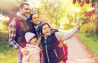 Image showing family with backpacks taking selfie by smartphone