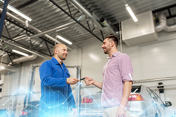 Image showing auto mechanic giving key to man at car shop