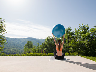 Image showing woman doing exercise with pilates ball