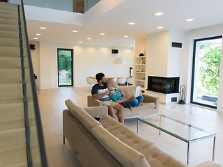 Image showing young happy couple relaxes in the living room