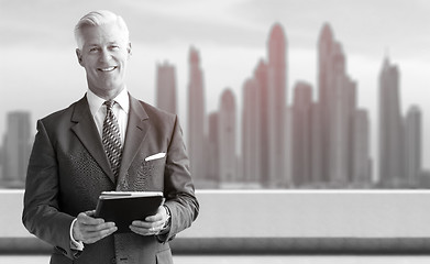 Image showing Senior businessman in front of the big city