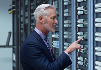 Image showing Senior businessman in server room