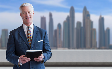 Image showing Senior businessman in front of the big city