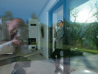 Image showing woman drinking coffee in front of her luxury home villa