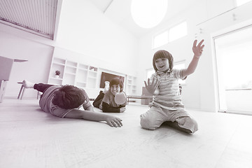 Image showing boys having fun with an apple on the floor