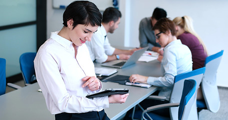 Image showing Portrait of  smiling casual businesswoman using tablet  with cow