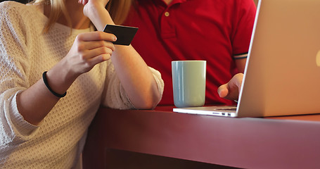 Image showing Couple Using Laptop To Shop Online in modern apartment