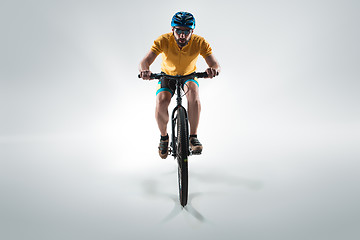 Image showing The bicyclist on gray, studio shot.