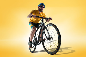 Image showing The bicyclist on gray, studio shot.