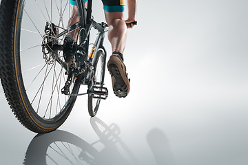 Image showing The bicyclist on gray, studio shot.