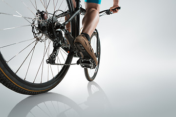 Image showing The bicyclist on gray, studio shot.