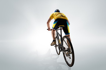 Image showing The bicyclist on gray, studio shot.