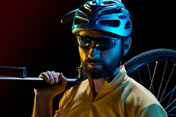 Image showing The bicyclist on black, studio shot.