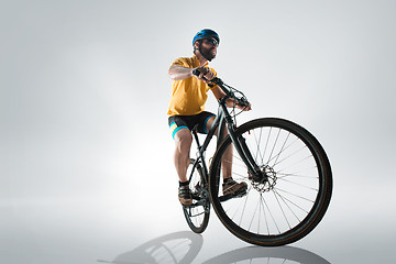 Image showing The bicyclist on gray, studio shot.