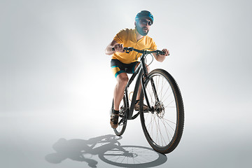 Image showing The bicyclist on gray, studio shot.