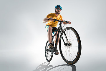 Image showing The bicyclist on gray, studio shot.