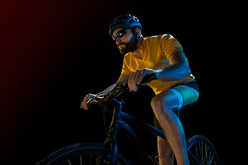 Image showing The bicyclist on black, studio shot.