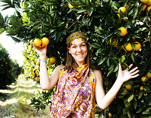 Image showing pretty woman in orange grove smiling