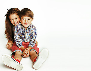 Image showing little cute boy and girl hugging playing on white background