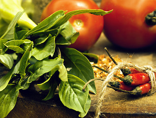 Image showing vegetables on wooden kitchen with spicies, tomato, chilli, green