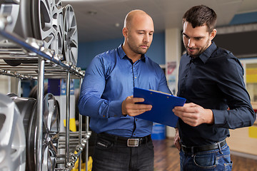 Image showing customer and salesman at car service or auto store