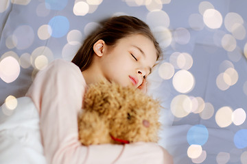 Image showing girl sleeping with teddy bear toy in bed