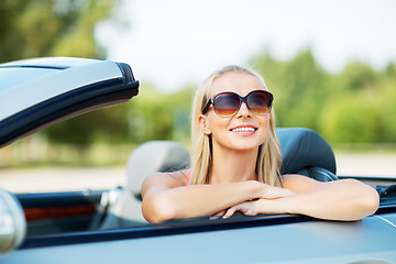 Image showing happy young woman in convertible car