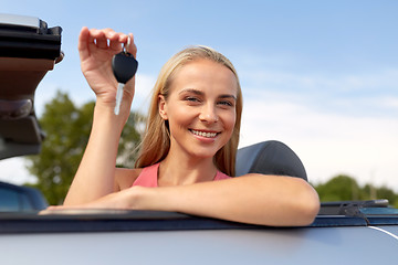 Image showing happy young woman with convertible car key