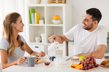 Image showing happy couple having breakfast at home