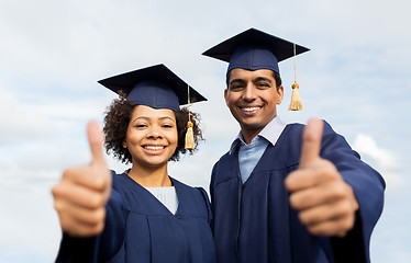 Image showing happy students or bachelors showing thumbs up