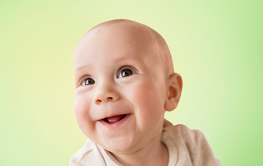 Image showing close up of happy little baby boy over green