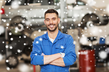 Image showing happy auto mechanic man or smith at car workshop