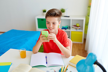 Image showing student boy with smartphone distracting from study