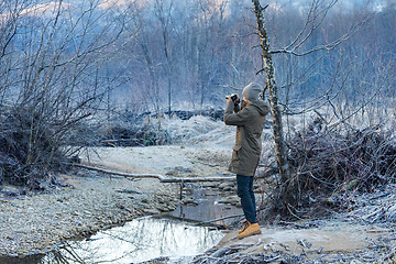 Image showing Photographer shoots winter forest