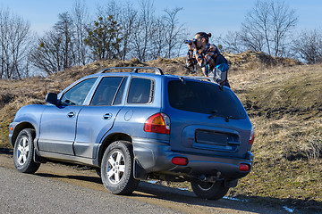 Image showing Photographer takes pictures from the car