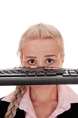 Image showing Woman holding the keyboard over her face