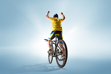 Image showing The bicyclist on gray, studio shot.