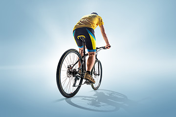 Image showing The bicyclist on gray, studio shot.