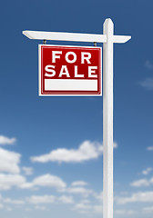 Image showing Left Facing For Sale Real Estate Sign on a Blue Sky with Clouds.